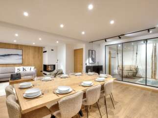 Experience luxury living in this stunning property, featuring a spacious dining area perfect for entertaining.