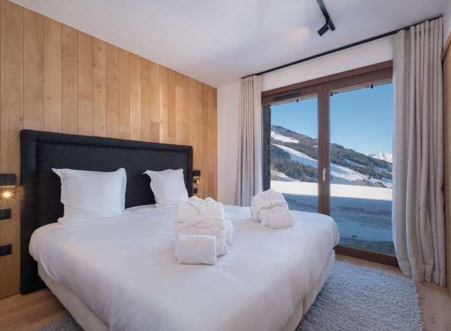 Experience luxury and breathtaking views in this stunning bedroom.