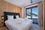 Experience luxury and breathtaking views in this stunning bedroom.