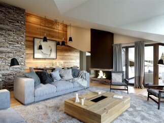 Experience luxury living in this stunning property, featuring a cozy living room with a fireplace and a stylish wooden accent wall.