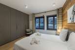 This cozy bedroom features two twin beds with crisp white linens, perfect for a comfortable stay.