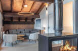Experience the warmth and charm of this stunning property, featuring a cozy living area with a modern fireplace.