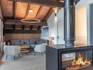 Experience the warmth and charm of this stunning property, featuring a cozy living area with a modern fireplace.