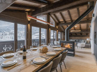 Experience luxury living in this stunning chalet, featuring a cozy fireplace and a spacious dining area perfect for entertaining.