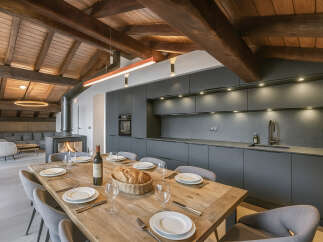 This stunning property boasts a modern kitchen with sleek cabinetry and a spacious dining area, perfect for entertaining.