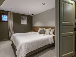 Step into this inviting bedroom, featuring a serene ambiance and modern design.