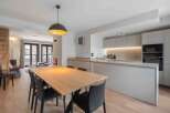 This modern kitchen and dining area is the perfect space for entertaining.