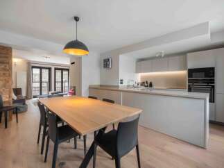 This modern kitchen and dining area is the perfect space for entertaining.