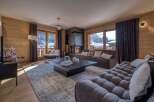 Experience the epitome of luxury living in this stunning property, featuring a cozy living room with a fireplace.