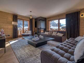 Experience the epitome of luxury living in this stunning property, featuring a cozy living room with a fireplace.