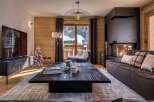 Experience luxury living in this stunning property, featuring a cozy living room with a fireplace and a stylish coffee table.