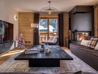 Experience luxury living in this stunning property, featuring a cozy living room with a fireplace and a stylish coffee table.