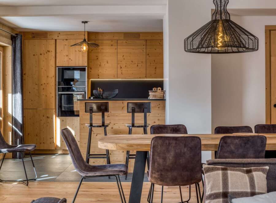 Experience the warmth of this stunning property, featuring a beautifully designed kitchen with custom wooden cabinetry and modern appliances.