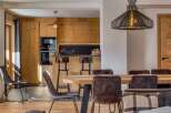 Experience the warmth of this stunning property, featuring a beautifully designed kitchen with custom wooden cabinetry and modern appliances.