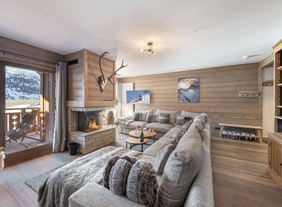 Experience luxury living in this stunning chalet, featuring a cozy fireplace, perfect for those chilly evenings.