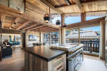 Experience luxury living in this stunning chalet, featuring a gourmet kitchen with top-of-the-line appliances and a spacious island.