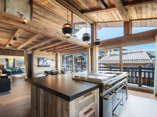 Experience luxury living in this stunning chalet, featuring a gourmet kitchen with top-of-the-line appliances and a spacious island.
