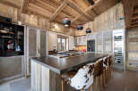 This stunning kitchen boasts a rustic yet modern design, perfect for a luxurious home.
