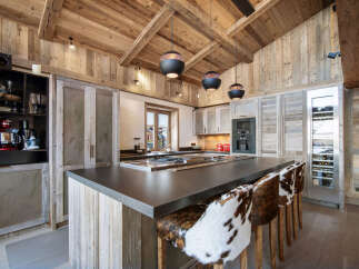 This stunning kitchen boasts a rustic yet modern design, perfect for a luxurious home.