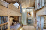 This charming bunk room features rustic wooden construction and cozy design elements, perfect for a mountain retreat.