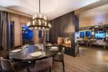 Experience luxury living in this stunning property featuring a modern dining area with a large round table and elegant chairs.