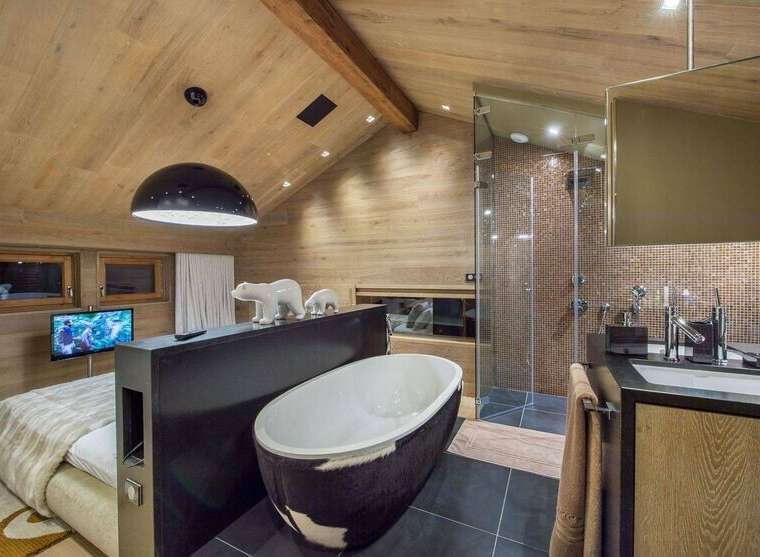 Experience luxury in this stunning bathroom featuring a unique cowhide-patterned bathtub and a modern glass shower.