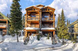 This stunning mountain property offers a luxurious retreat with its spacious balconies and inviting wooden architecture.
