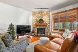 This cozy living room features a stunning stone fireplace, perfect for those chilly evenings.
