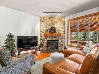 This cozy living room features a stunning stone fireplace, perfect for those chilly evenings.