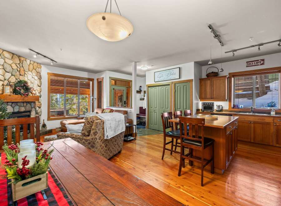 This stunning property features a cozy living room with a stone fireplace, perfect for relaxing evenings.