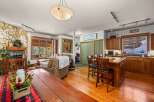 This stunning property features a cozy living room with a stone fireplace, perfect for relaxing evenings.