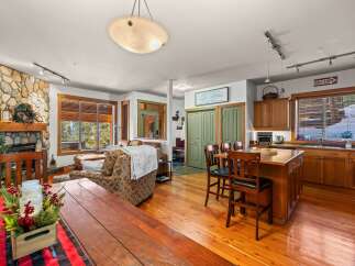 This stunning property features a cozy living room with a stone fireplace, perfect for relaxing evenings.