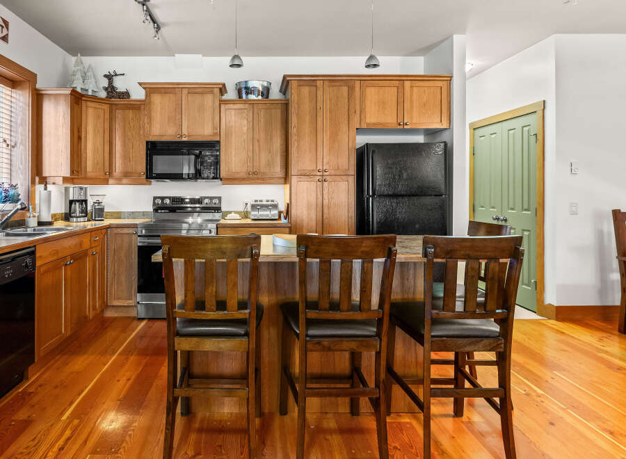 This stunning kitchen boasts beautiful wooden cabinetry and a spacious layout, perfect for both cooking and entertaining.