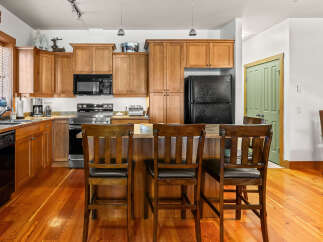 This stunning kitchen boasts beautiful wooden cabinetry and a spacious layout, perfect for both cooking and entertaining.