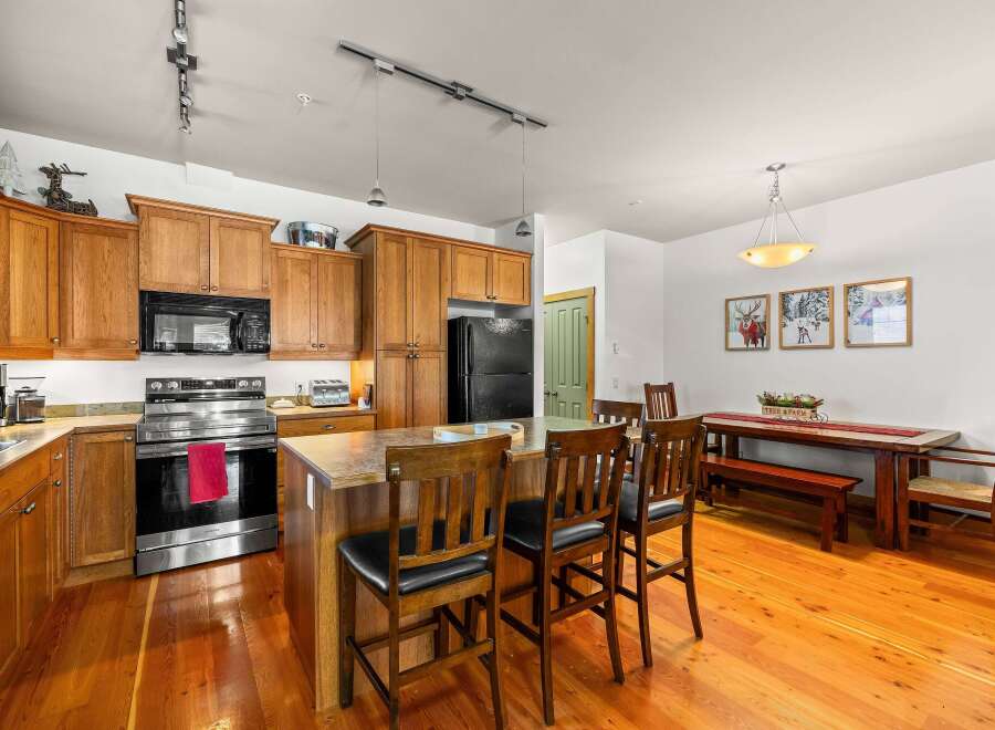 This stunning kitchen boasts beautiful wooden cabinetry and a spacious layout, perfect for both cooking and entertaining.