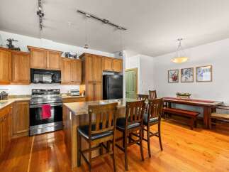 This stunning kitchen boasts beautiful wooden cabinetry and a spacious layout, perfect for both cooking and entertaining.