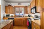 This stunning kitchen boasts beautiful wooden cabinetry and a modern appliance suite.
