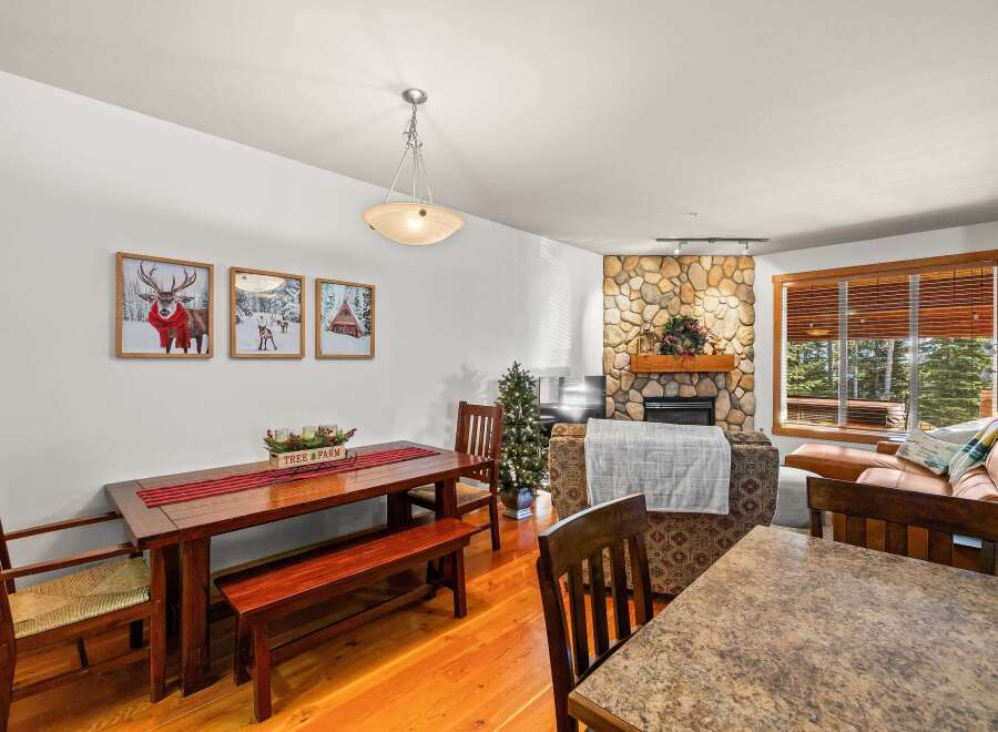 This cozy living space features a stunning stone fireplace, perfect for those chilly evenings.