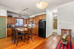 This stunning kitchen boasts beautiful wooden cabinetry and flooring, creating a warm and inviting atmosphere.