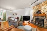 This cozy living space features a stunning stone fireplace, perfect for those chilly evenings.