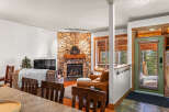 This cozy living space features a stunning stone fireplace, perfect for those chilly evenings.