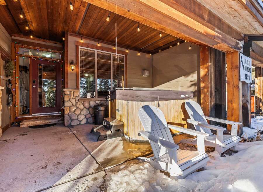Enjoy the ultimate relaxation in this stunning outdoor space! Featuring a luxurious hot tub, comfortable Adirondack chairs, and a charming wooden ceiling with string lights, this property offers a perfect blend of comfort and style.