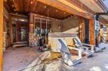Enjoy the ultimate relaxation in this stunning outdoor space! Featuring a luxurious hot tub, comfortable Adirondack chairs, and a charming wooden ceiling with string lights, this property offers a perfect blend of comfort and style.