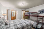 This cozy bedroom features a comfortable bed with a stylish plaid comforter and a decorative pillow.