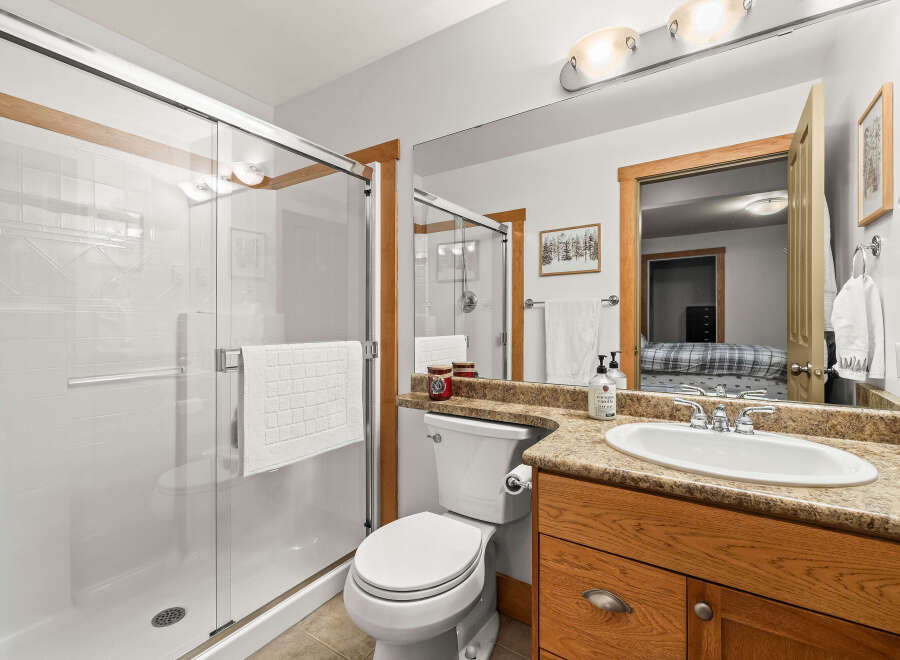This stunning bathroom boasts a modern design with a spacious walk-in shower, perfect for a relaxing experience.