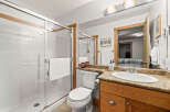 This stunning bathroom boasts a modern design with a spacious walk-in shower, perfect for a relaxing experience.