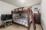 This cozy bedroom features a charming bunk bed, perfect for accommodating guests or creating a fun space for kids.