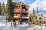 This stunning mountain lodge offers a luxurious retreat with its multi-level design and expansive balconies.