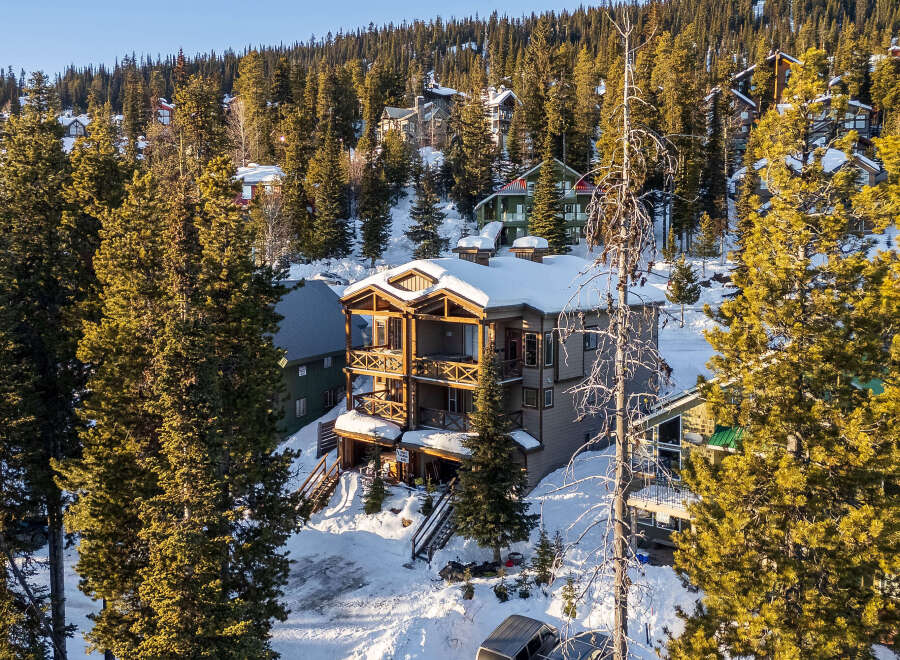 This stunning mountain property offers a luxurious retreat with its multi-level design and expansive balconies.