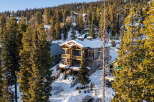This stunning mountain property offers a luxurious retreat with its multi-level design and expansive balconies.